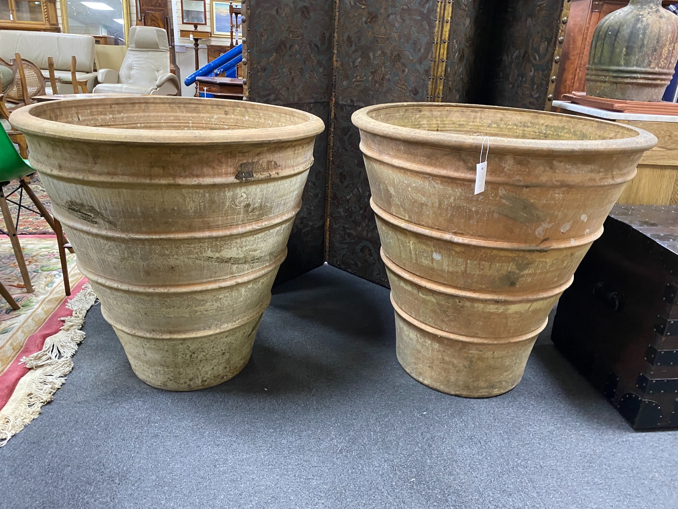 A near pair of Grecian style circular earthenware garden planters, larger diameter 82cm, height 82cm